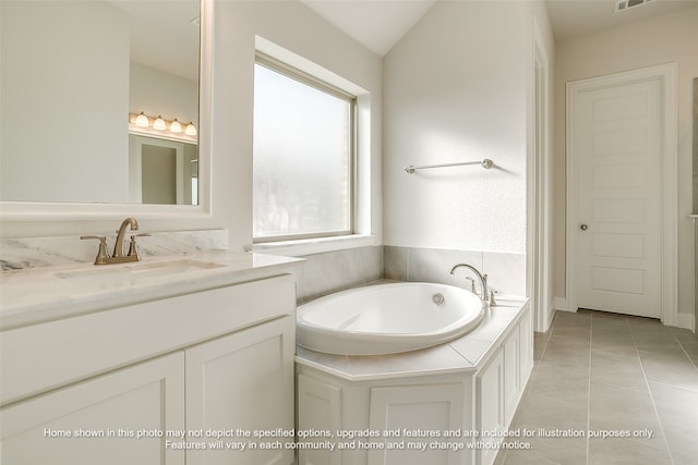 bathroom featuring lofted ceiling, visible vents, vanity, a bath, and tile patterned floors