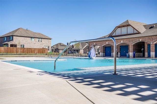 view of pool featuring fence