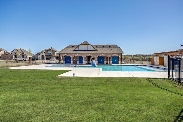 view of swimming pool featuring a patio area, fence, a fenced in pool, and a yard