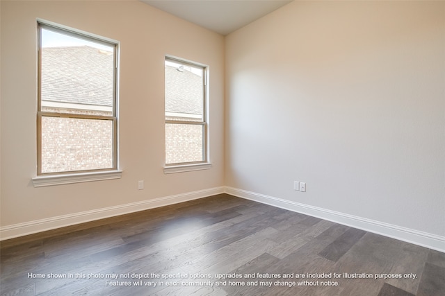 empty room featuring dark wood finished floors and baseboards