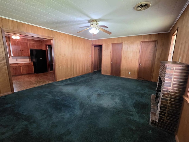 unfurnished bedroom featuring crown molding, wooden walls, carpet, and visible vents