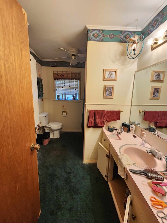 bathroom featuring vanity, ceiling fan, and toilet