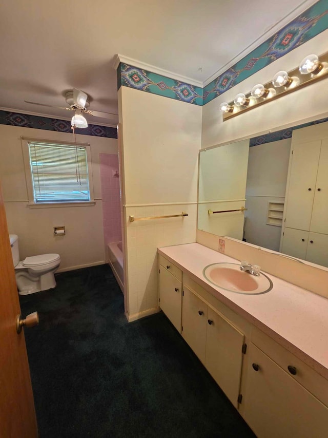 full bath featuring toilet, a shower, a ceiling fan, a tub to relax in, and vanity