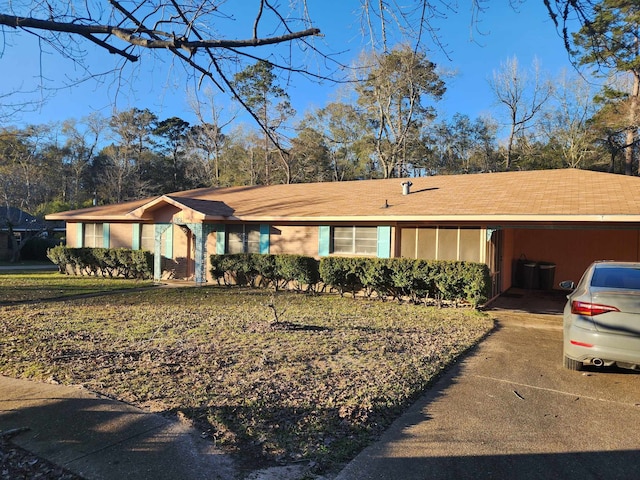 single story home with a carport and driveway