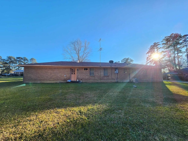 back of property featuring a lawn