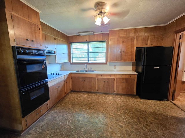 kitchen featuring crown molding, ceiling fan, black appliances, light countertops, and a sink