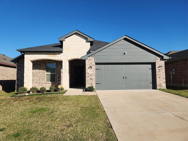 view of front of home with a front yard and a garage