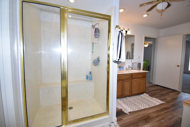 bathroom featuring hardwood / wood-style flooring, vanity, and walk in shower