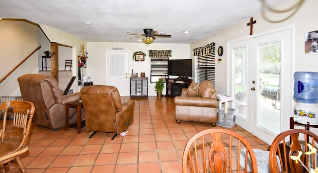 living room with ceiling fan and light tile patterned flooring