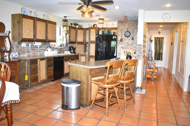 kitchen with decorative backsplash, ceiling fan, light tile patterned floors, and black appliances