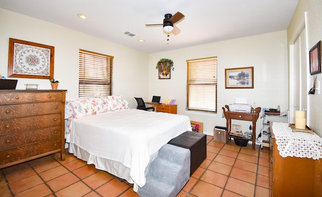 bedroom with ceiling fan and light tile patterned floors