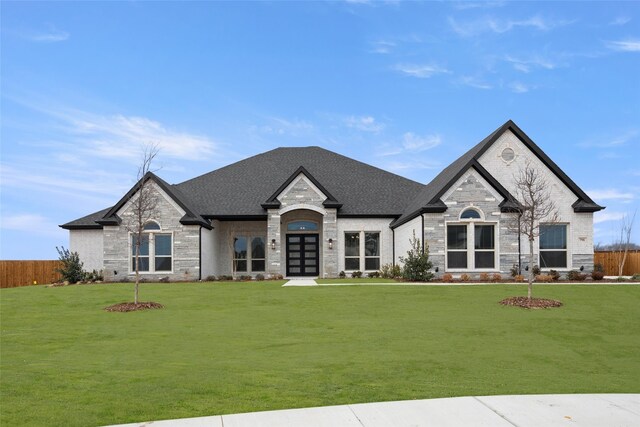 french country home featuring a front lawn and french doors