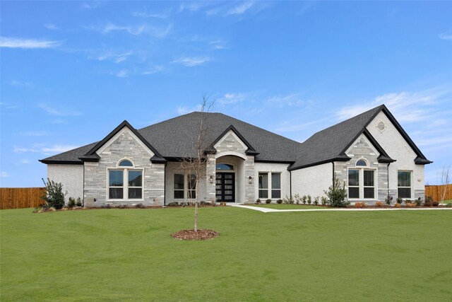 french country style house featuring a front lawn and french doors