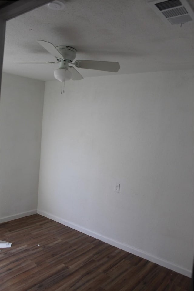 unfurnished room with ceiling fan and dark hardwood / wood-style floors