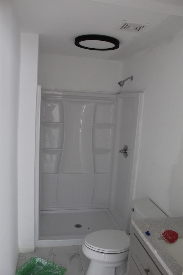 bathroom featuring toilet and a shower