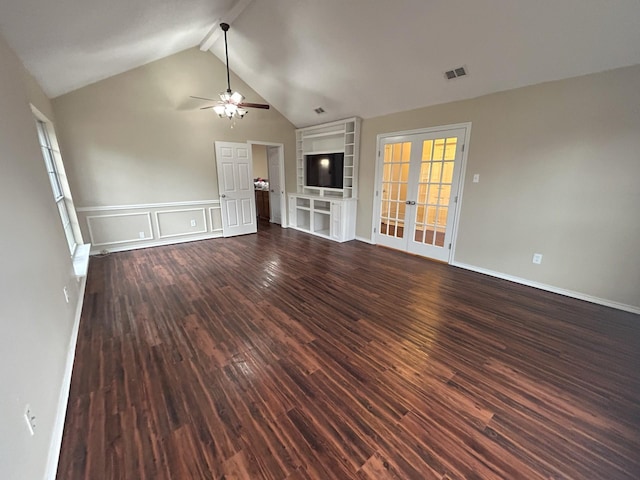 unfurnished living room with dark wood-type flooring, french doors, vaulted ceiling with beams, ceiling fan, and built in shelves