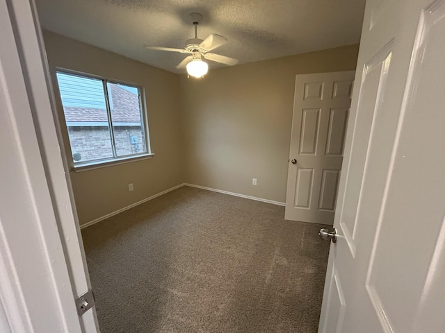 carpeted empty room with ceiling fan and a textured ceiling