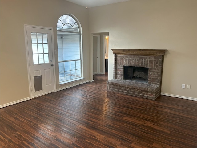 unfurnished living room featuring a fireplace and dark hardwood / wood-style flooring