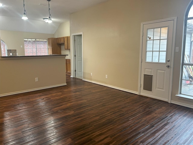 entryway with dark wood-type flooring and vaulted ceiling