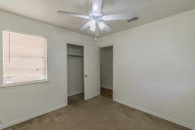 unfurnished bedroom with carpet, ceiling fan, and a closet