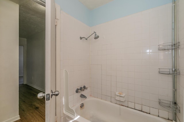 bathroom with tiled shower / bath combo and wood-type flooring