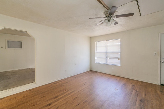 empty room featuring hardwood / wood-style flooring and ceiling fan