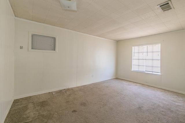 carpeted spare room with ornamental molding