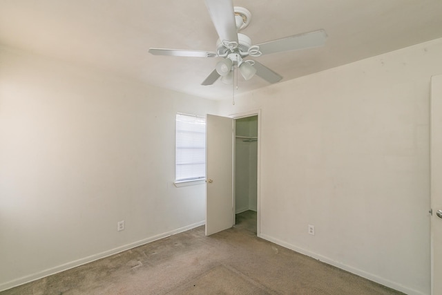 unfurnished bedroom featuring ceiling fan, a closet, and light colored carpet