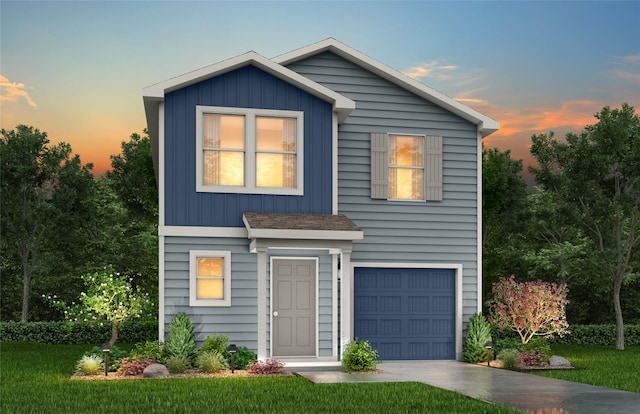 view of front facade featuring a garage and a yard