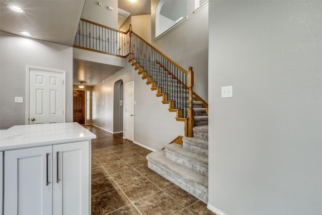 stairway featuring a high ceiling