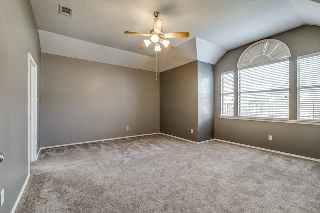 unfurnished room featuring ceiling fan, light colored carpet, and vaulted ceiling