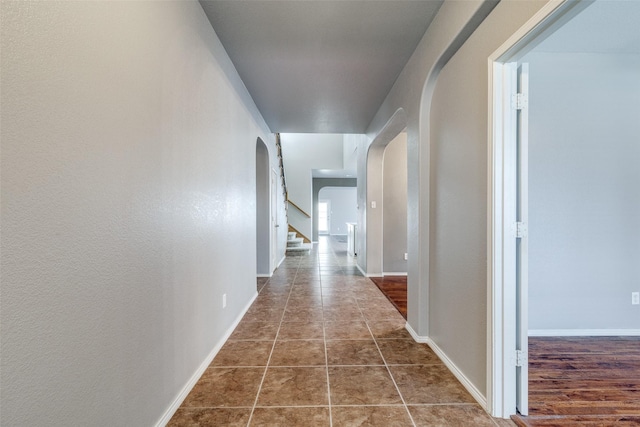 hall with dark tile patterned flooring