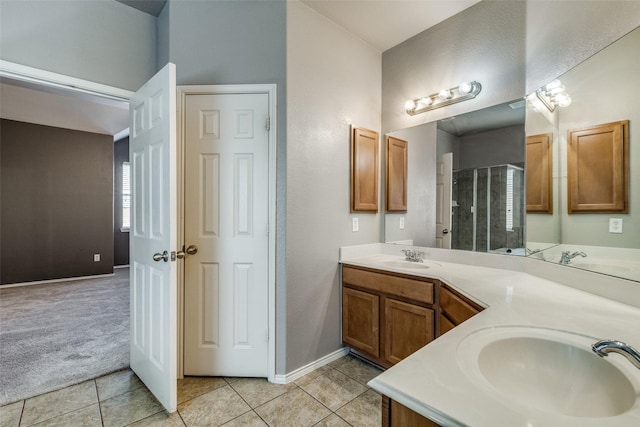 bathroom featuring vanity, a shower with shower door, and tile patterned floors