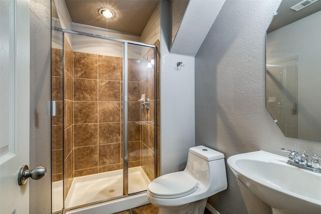 bathroom featuring sink, toilet, and walk in shower