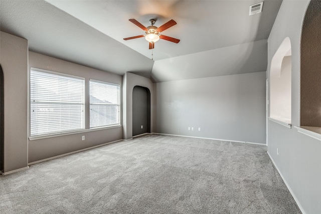 unfurnished room with vaulted ceiling, light carpet, and ceiling fan