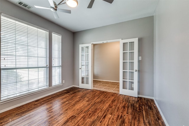 spare room with ceiling fan, dark wood-type flooring, and french doors