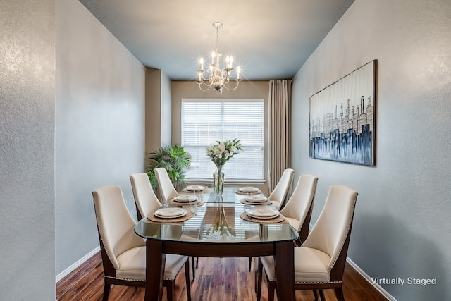 dining area featuring an inviting chandelier and dark hardwood / wood-style floors