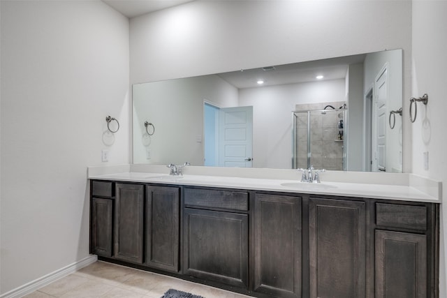 bathroom with tile patterned floors, vanity, and a shower with shower door