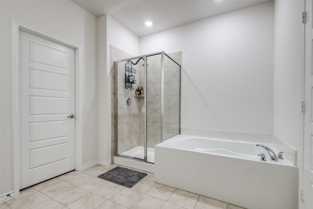 bathroom featuring tile patterned floors and independent shower and bath