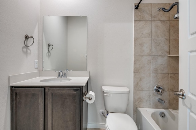 full bathroom with vanity, tiled shower / bath combo, and toilet