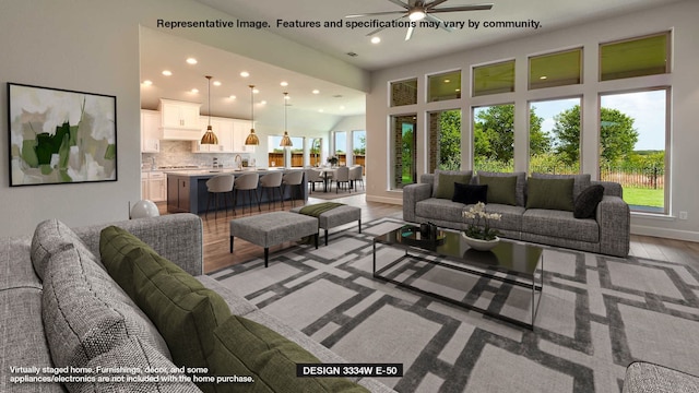 living room with ceiling fan and light hardwood / wood-style floors