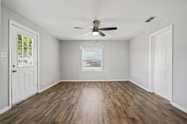 unfurnished room with ceiling fan and dark wood-type flooring