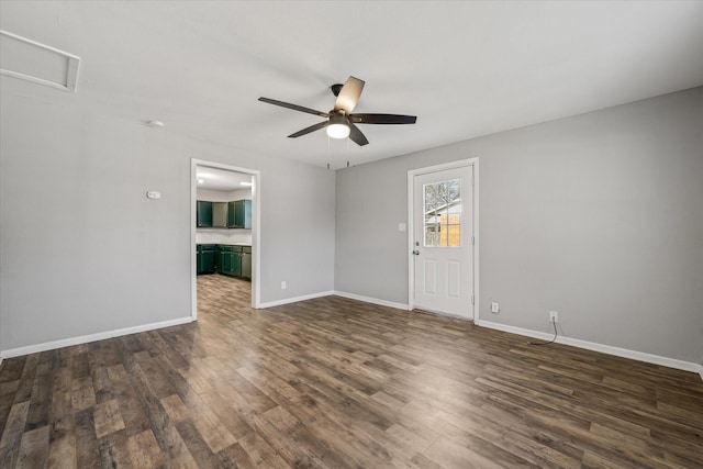 spare room with ceiling fan and dark hardwood / wood-style flooring