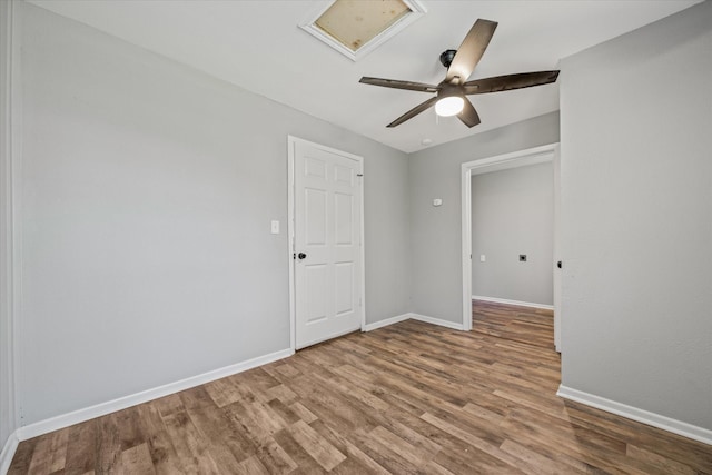 unfurnished room with ceiling fan and wood-type flooring