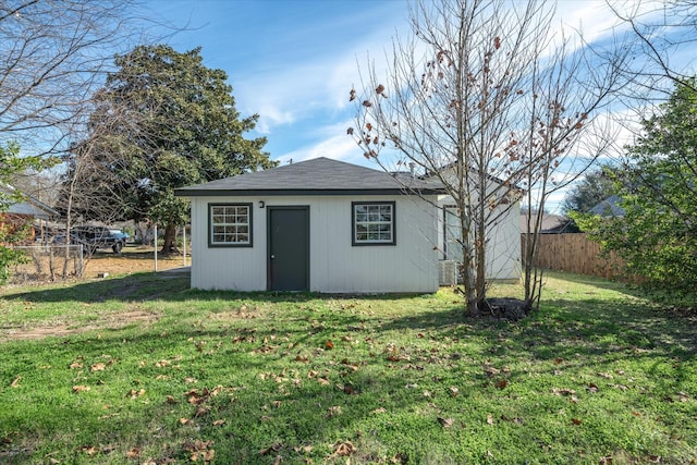 view of outbuilding with central AC unit and a yard