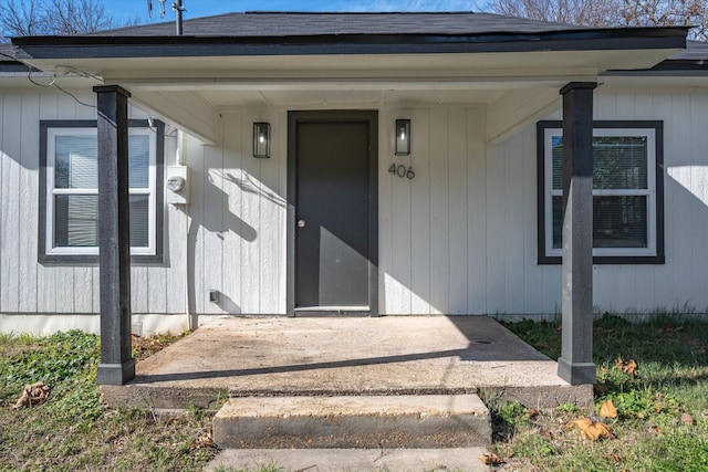 view of exterior entry with a patio area