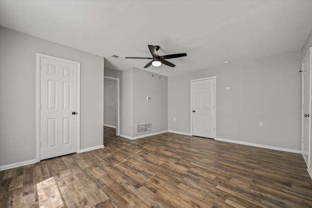 empty room with dark hardwood / wood-style floors and ceiling fan