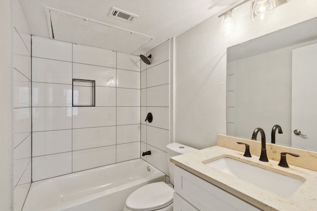 full bathroom with tiled shower / bath combo, toilet, and vanity