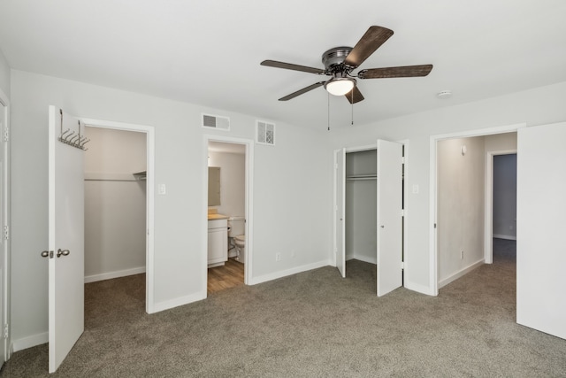 unfurnished bedroom with carpet flooring, connected bathroom, and ceiling fan