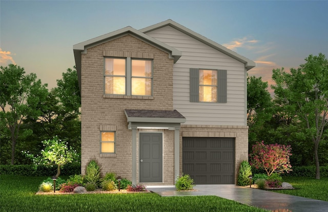 view of front of home with a yard and a garage